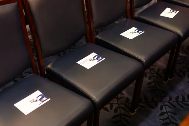 Event handout cards placed on leather chairs in the briefing room.