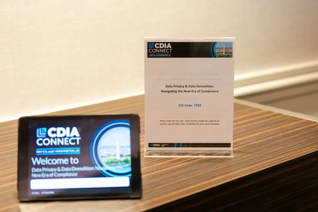 Session sign and welcome tablet on a wood ledge.