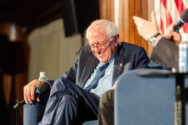Bernie Sanders laughing on stage during an onstage conversation at the National Press Club.